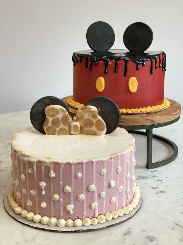Mickey Mouse and Minnie Mouse themed cakes on stands