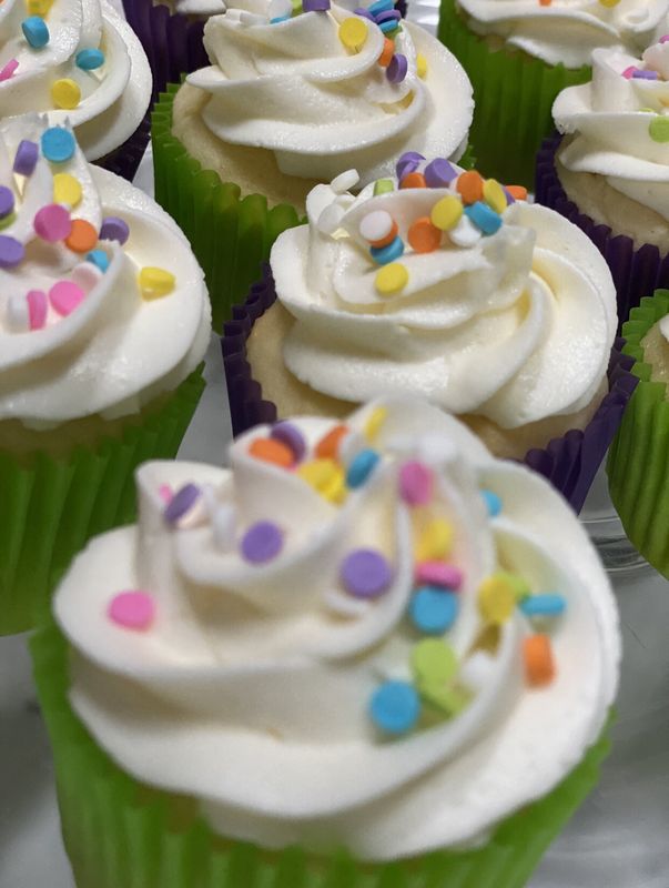 Vanilla cupcakes with buttercream swirls and confetti sprinkles